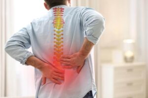 Man suffering pain from spinal cord injury.