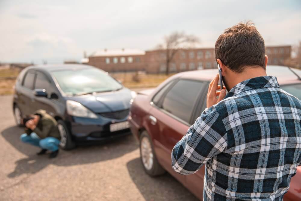 Drivers calling insurance to report accident.